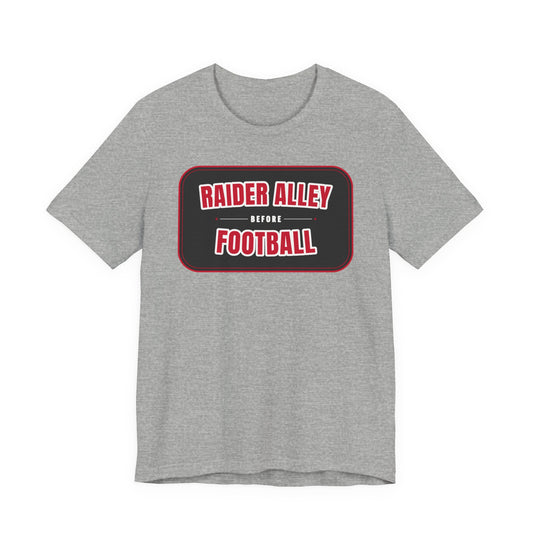 Athletic heather gray crewneck tee with red-bordered "RAIDER ALLEY BEFORE FOOTBALL" graphic.