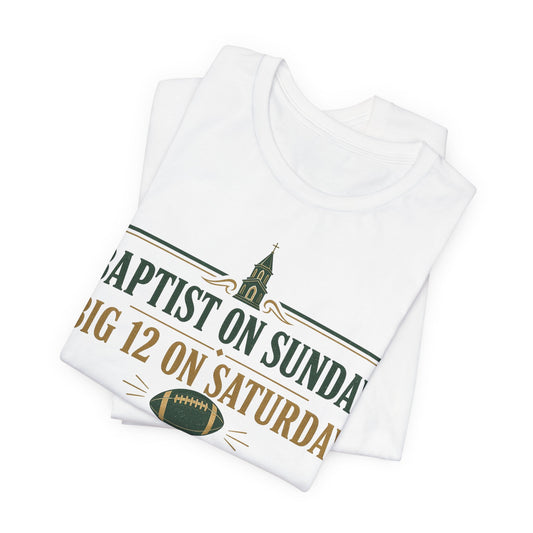 White crewneck graphic tee, folded/stacked, with 'Baptist on Sunday' football text