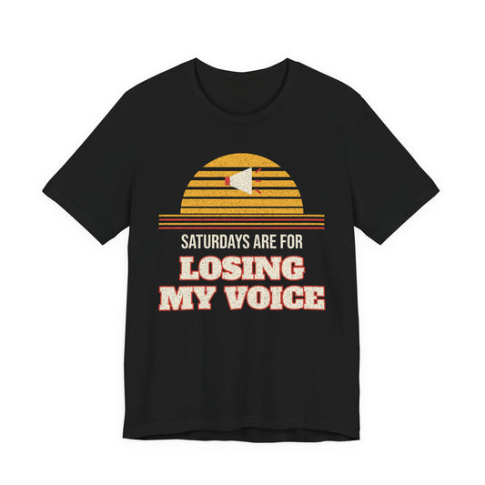 Black T-shirt with retro sunburst graphic and “Saturdays are for Losing My Voice” print.