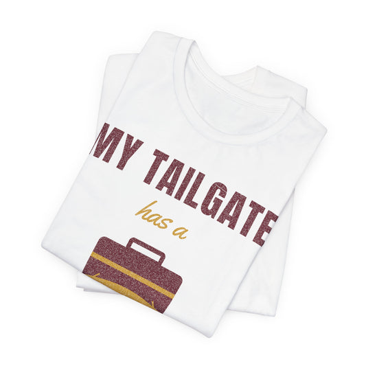 White folded graphic tee showing 'MY TAILGATE has a' and cooler-on-tube artwork