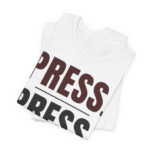 Folded white “PRESS.” graphic t-shirt, close view of stacked lettering