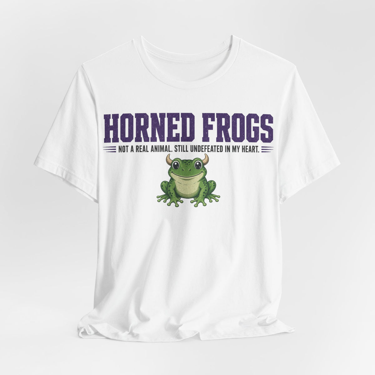 White graphic t-shirt with 'Horned Frogs' headline, small slogan, and green frog