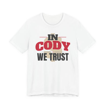 White graphic T-shirt with large 'IN CODY' and 'WE TRUST' text on chest