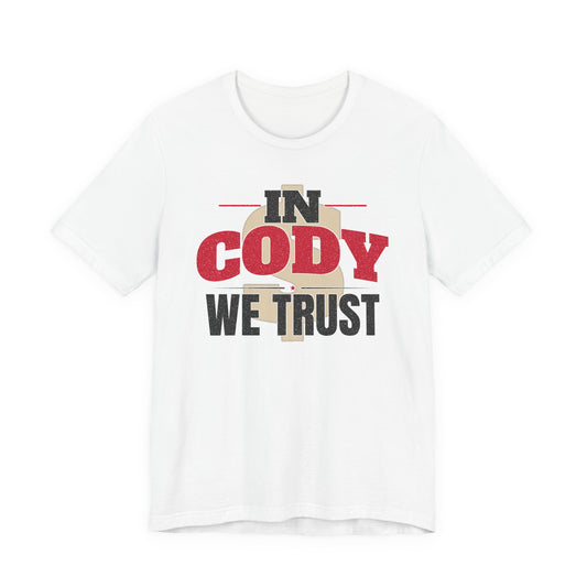 White graphic T-shirt with large 'IN CODY' and 'WE TRUST' text on chest