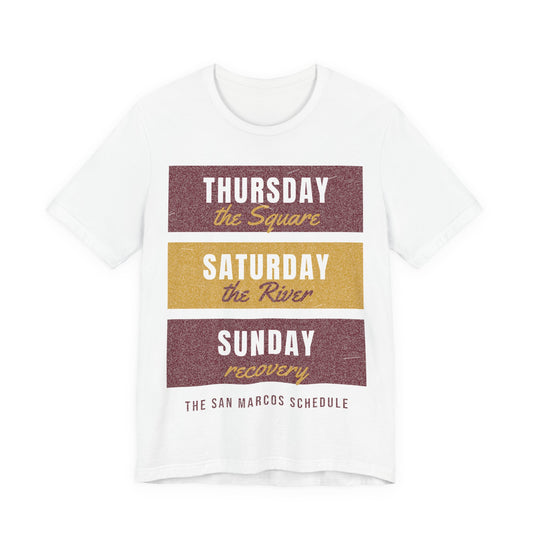 White tee with Thursday–Saturday–Sunday schedule graphic text on front
