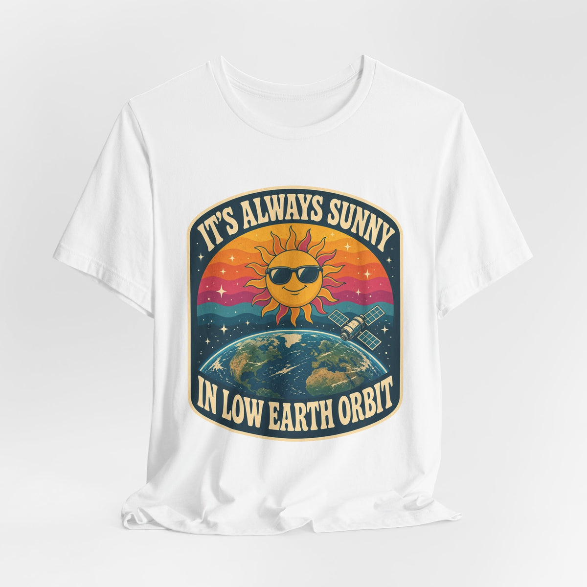 White crewneck T-shirt with colorful sun-and-Earth “It’s Always Sunny in Low Earth Orbit” graphic.