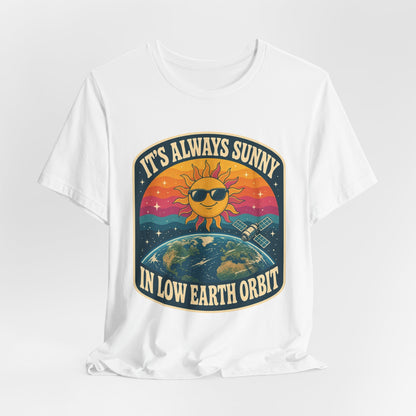 White crewneck T-shirt with colorful sun-and-Earth “It’s Always Sunny in Low Earth Orbit” graphic.