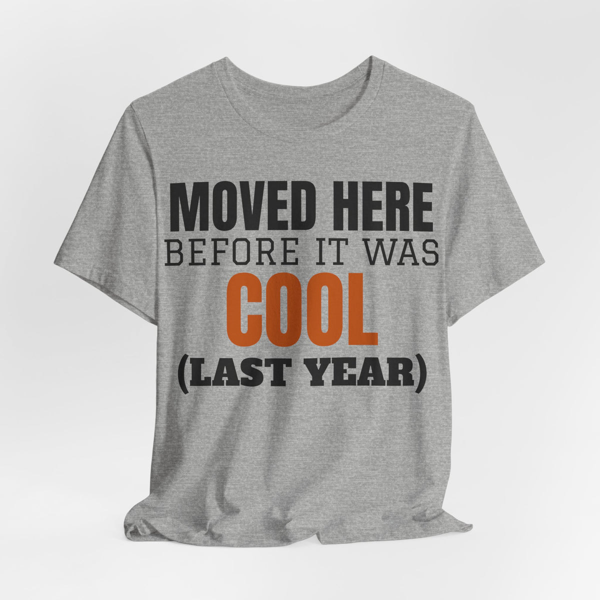 Heather gray crewneck T-shirt with "Moved Here Before It Was Cool (Last Year)" text graphic