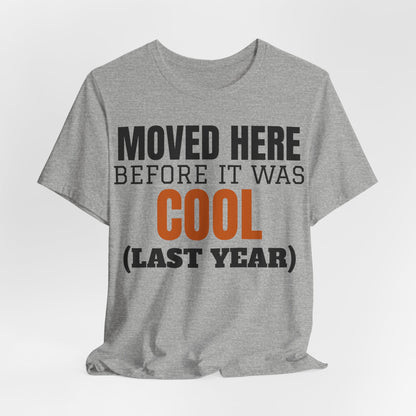 Heather gray crewneck T-shirt with "Moved Here Before It Was Cool (Last Year)" text graphic