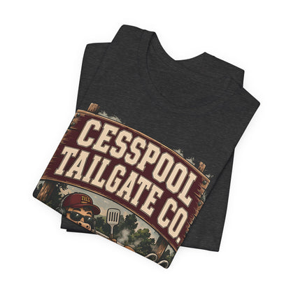 Dark heather T-shirt, folded, with large Cesspool Tailgate Co. logo and grill graphic
