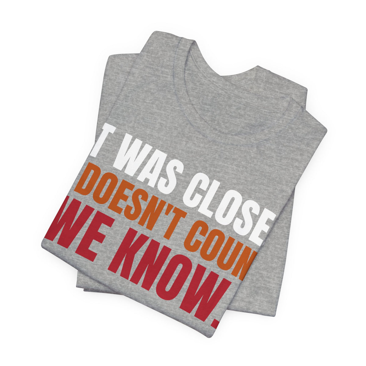 Folded athletic heather graphic tee with "DOESN'T COUNT" and "WE KNOW" in red/orange