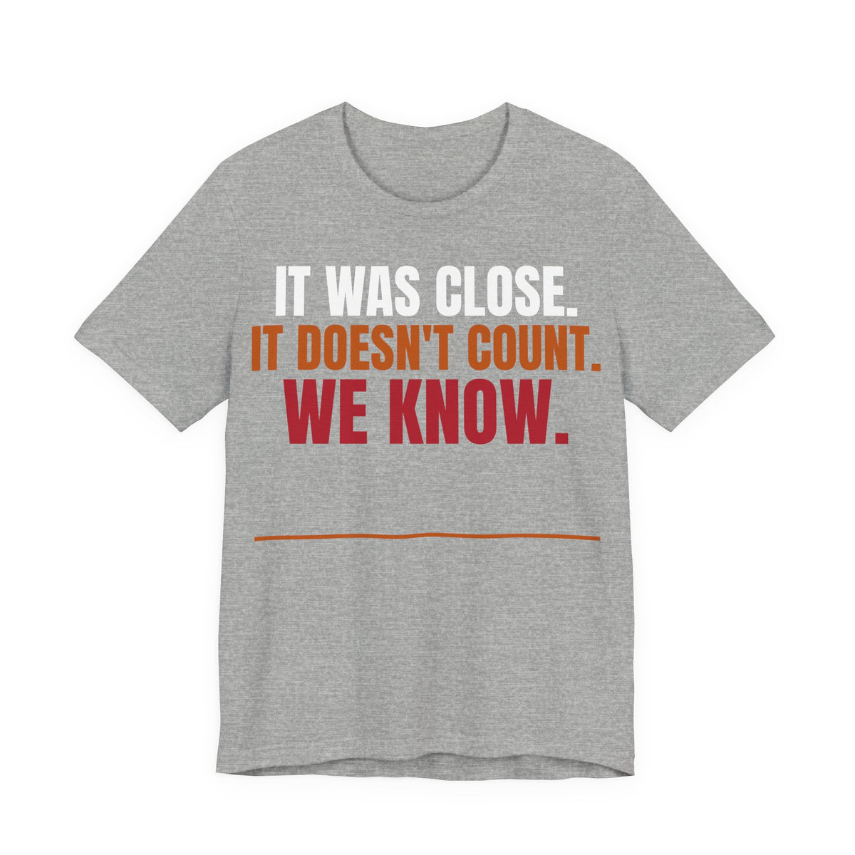 Athletic heather graphic tee with "IT WAS CLOSE" slogan in white, orange, and red