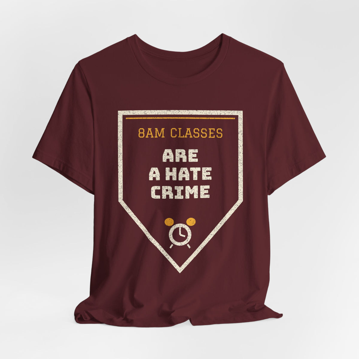Maroon crewneck T-shirt with shield logo reading "8am Classes Are a Hate Crime"
