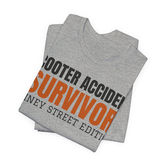 Heather gray graphic T-shirt showing bold orange Scooter Accident Survivor Rainy Street Edition