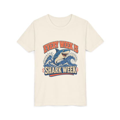 Kids short-sleeve tee, natural/cream, crew neck, “Every Week Is Shark Week” graphic.