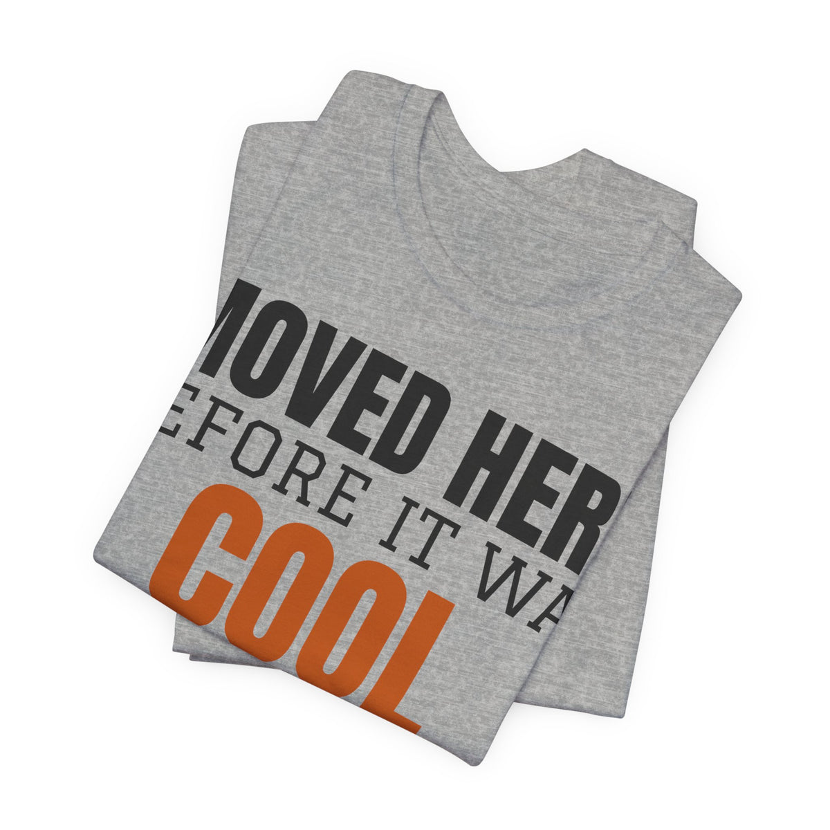 Heather gray T-shirt shown folded with large "MOVED HERE" and orange "COOL" graphic