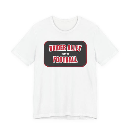 White crewneck tee shirt with red-bordered "RAIDER ALLEY BEFORE FOOTBALL" graphic.