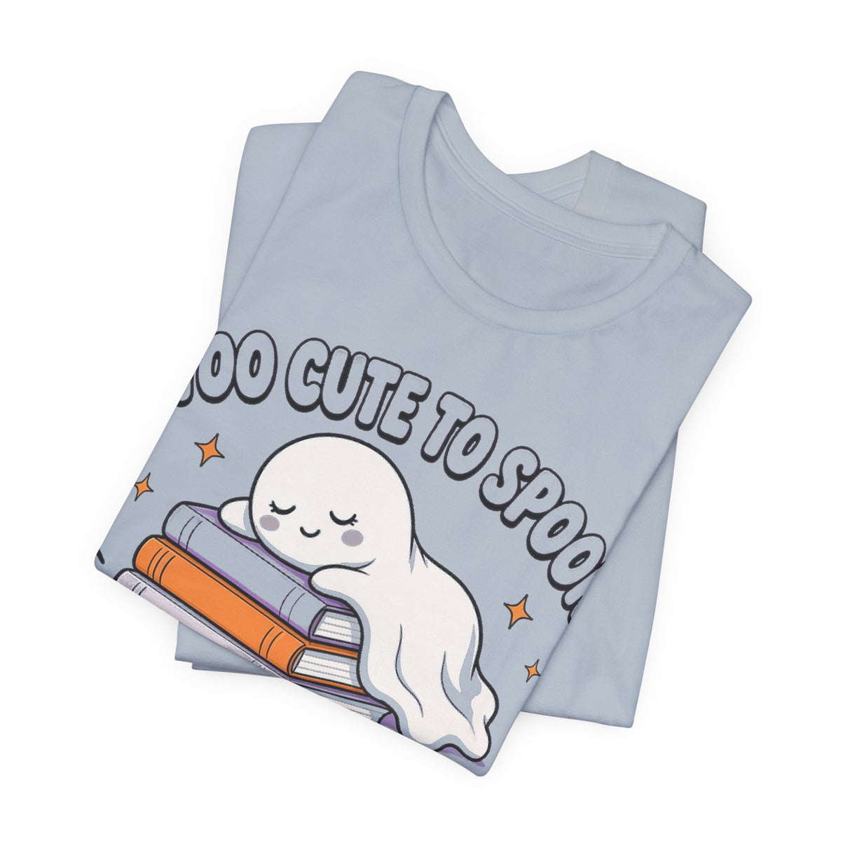Light blue tee in flat lay, featuring smiling ghost cuddling stacked books print
