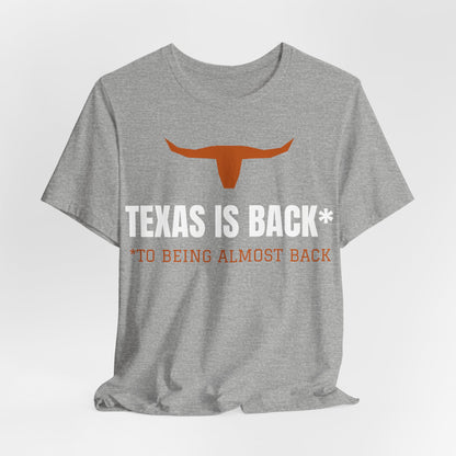Athletic heather Texas Is Back* tee with orange longhorn and 'to being almost back' line