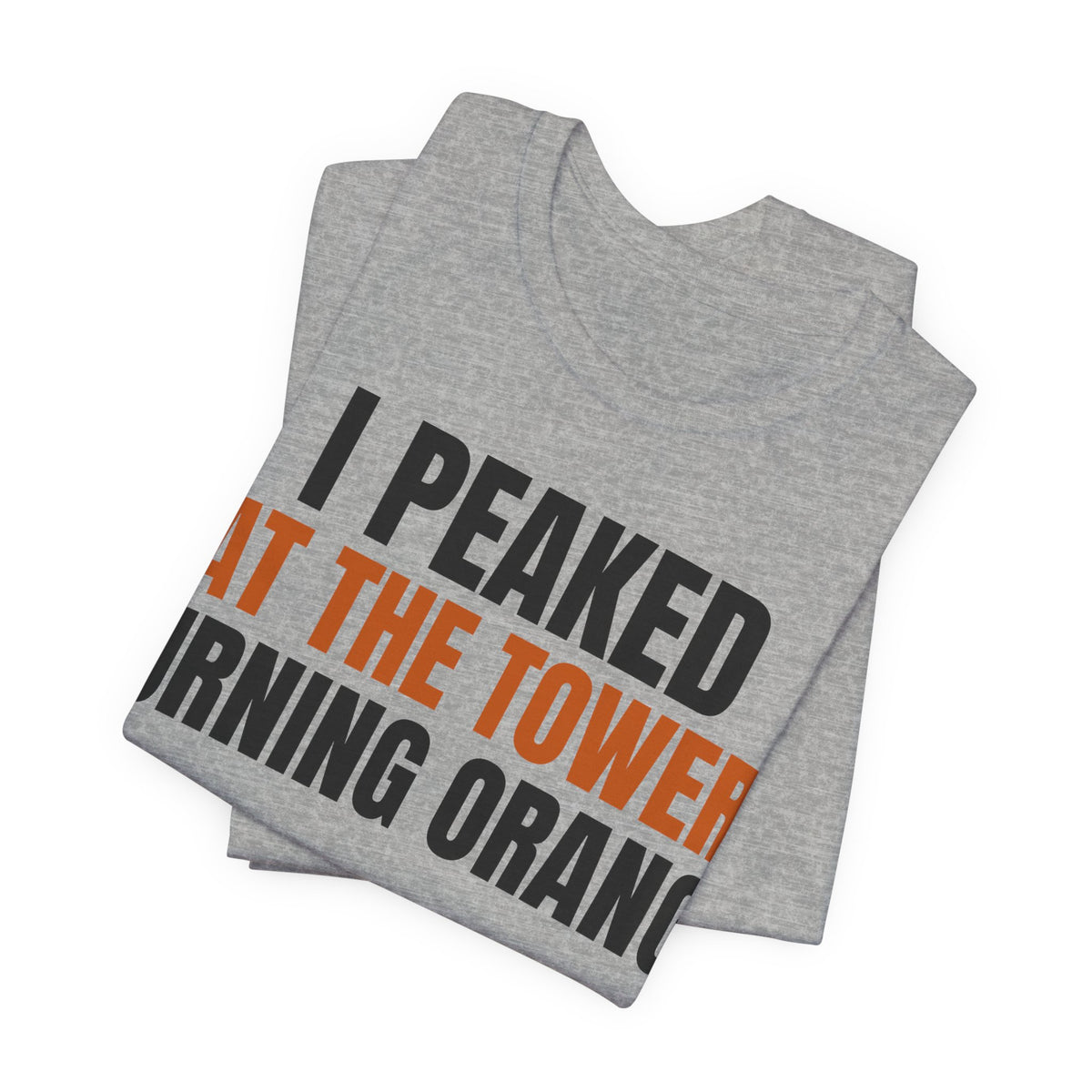 Heather gray folded T-shirt with orange/black 'I PEAKED AT THE TOWER TURNING ORANGE' design.