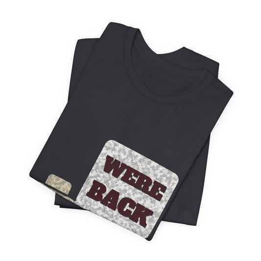 Dark grey graphic tee, crew neck, short sleeves, 'WE'RE BACK' poster-style print