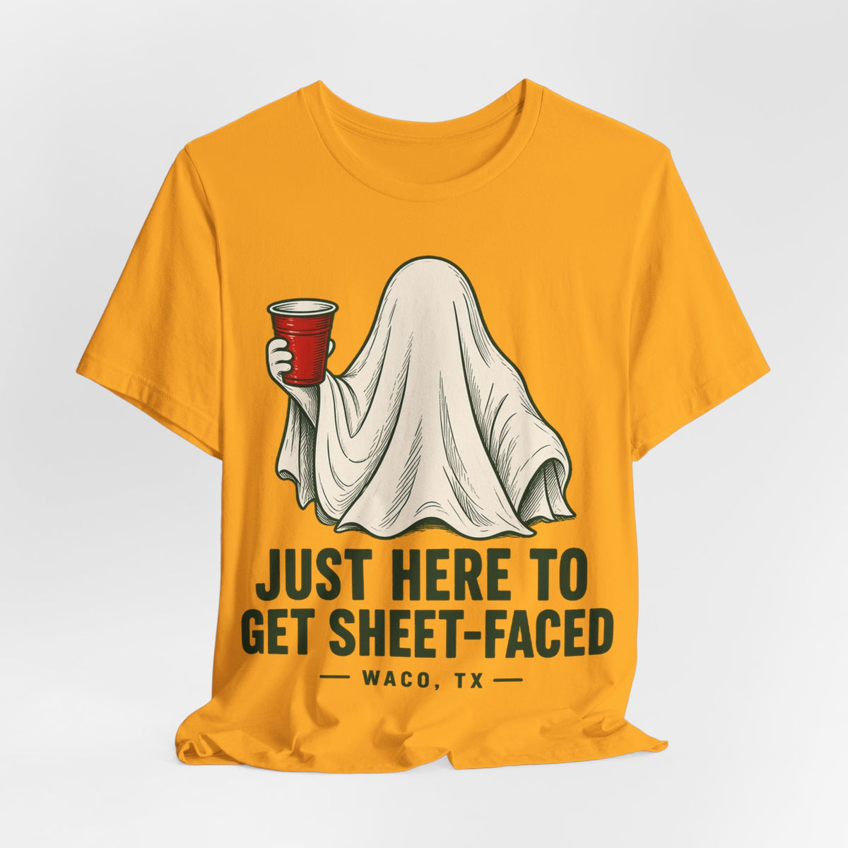Gold crewneck T-shirt with ghost graphic and Just here to get sheet-faced print