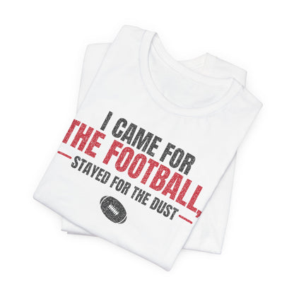 White folded football graphic t-shirt showing red and black “THE FOOTBALL” print
