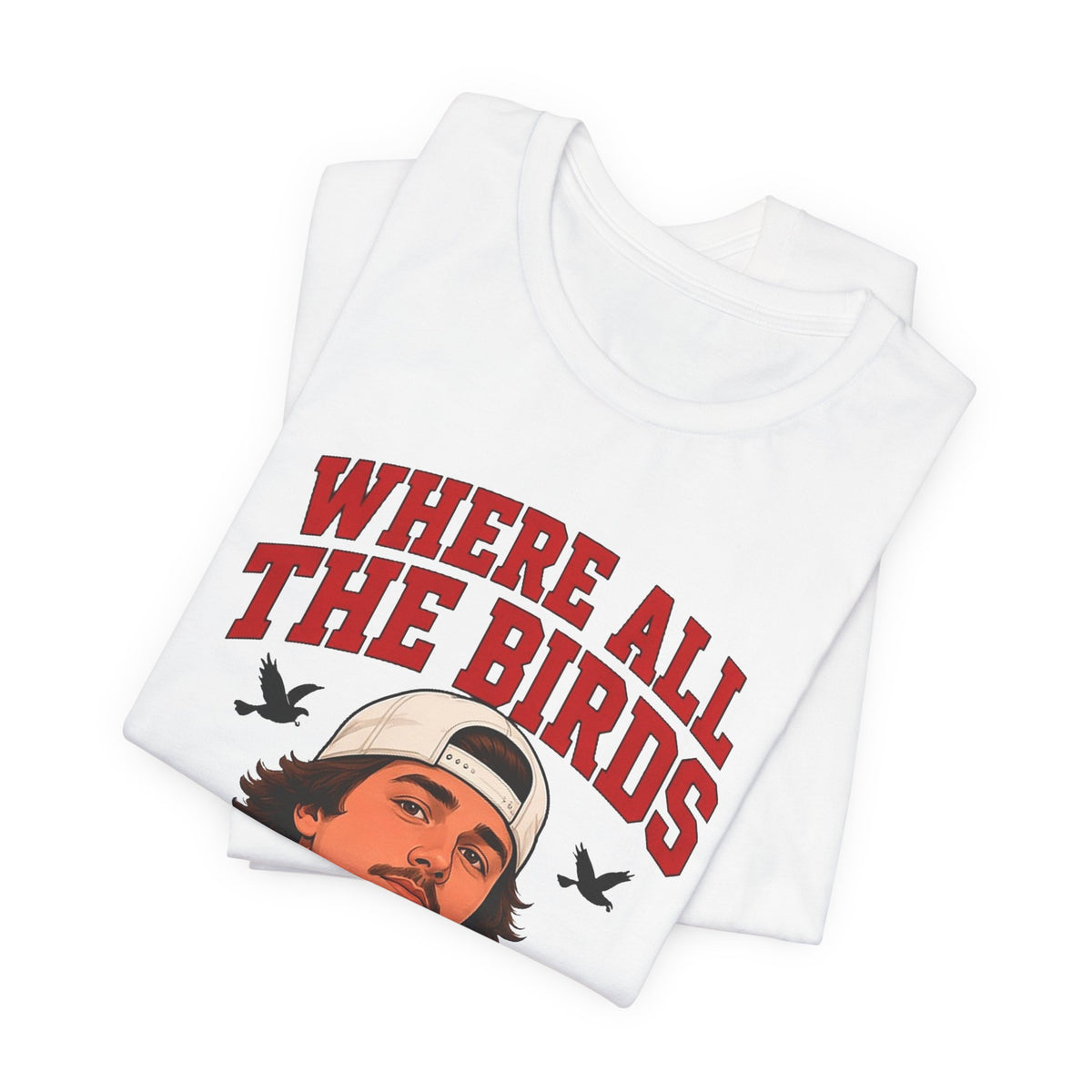 White crewneck graphic tee, folded, with illustrated man and bold red 'WHERE ALL THE BIRDS' print.