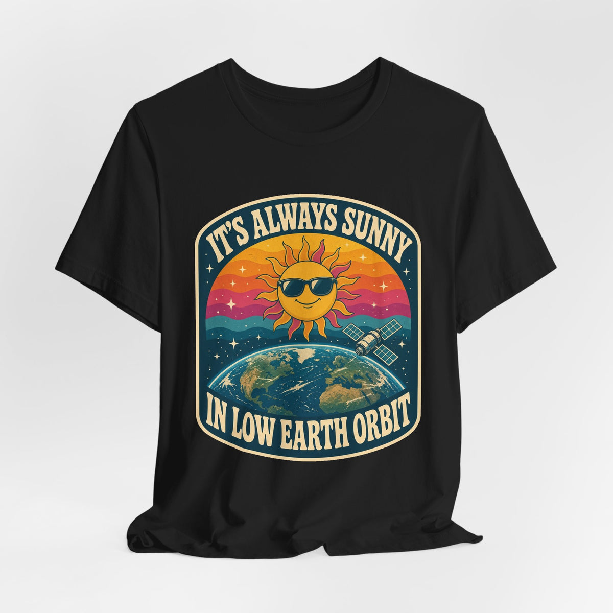 Black crewneck T-shirt with colorful sun-and-Earth “It’s Always Sunny in Low Earth Orbit” graphic.