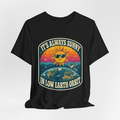 Black crewneck T-shirt with colorful sun-and-Earth “It’s Always Sunny in Low Earth Orbit” graphic.