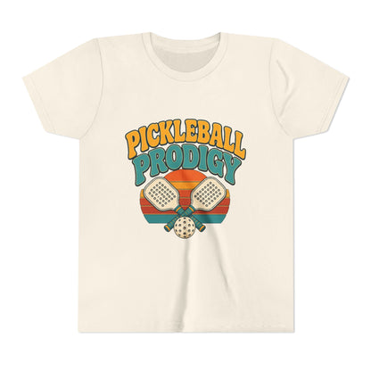 Kids natural/cream pickleball tee with colorful "Pickleball Prodigy" graphic and paddles