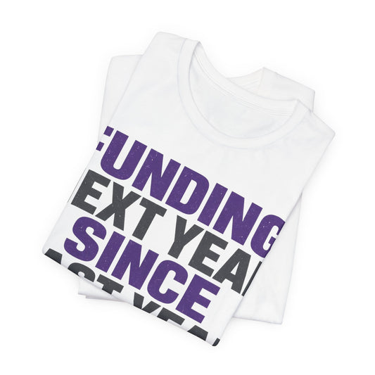 White tee showing diagonal Funding Next Year Since Last Year text with piggy bank and calendar