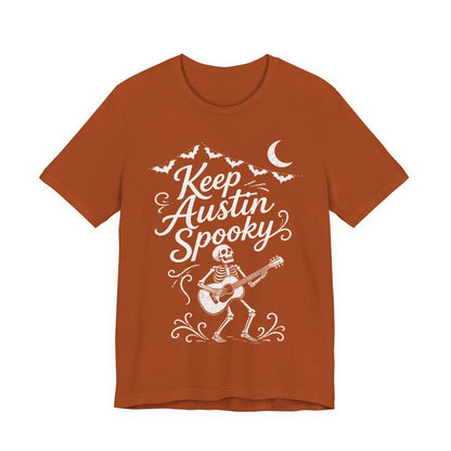 Rust orange crewneck tee with white "Keep Austin Spooky" skeleton guitar graphic