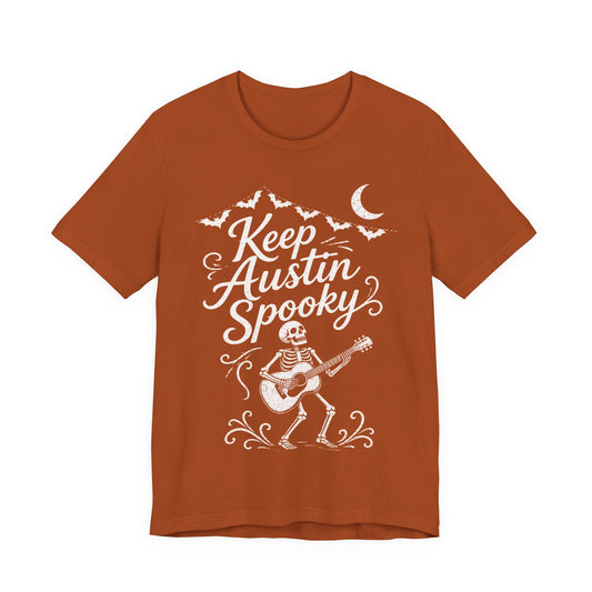 Rust orange crewneck tee with white "Keep Austin Spooky" skeleton guitar graphic
