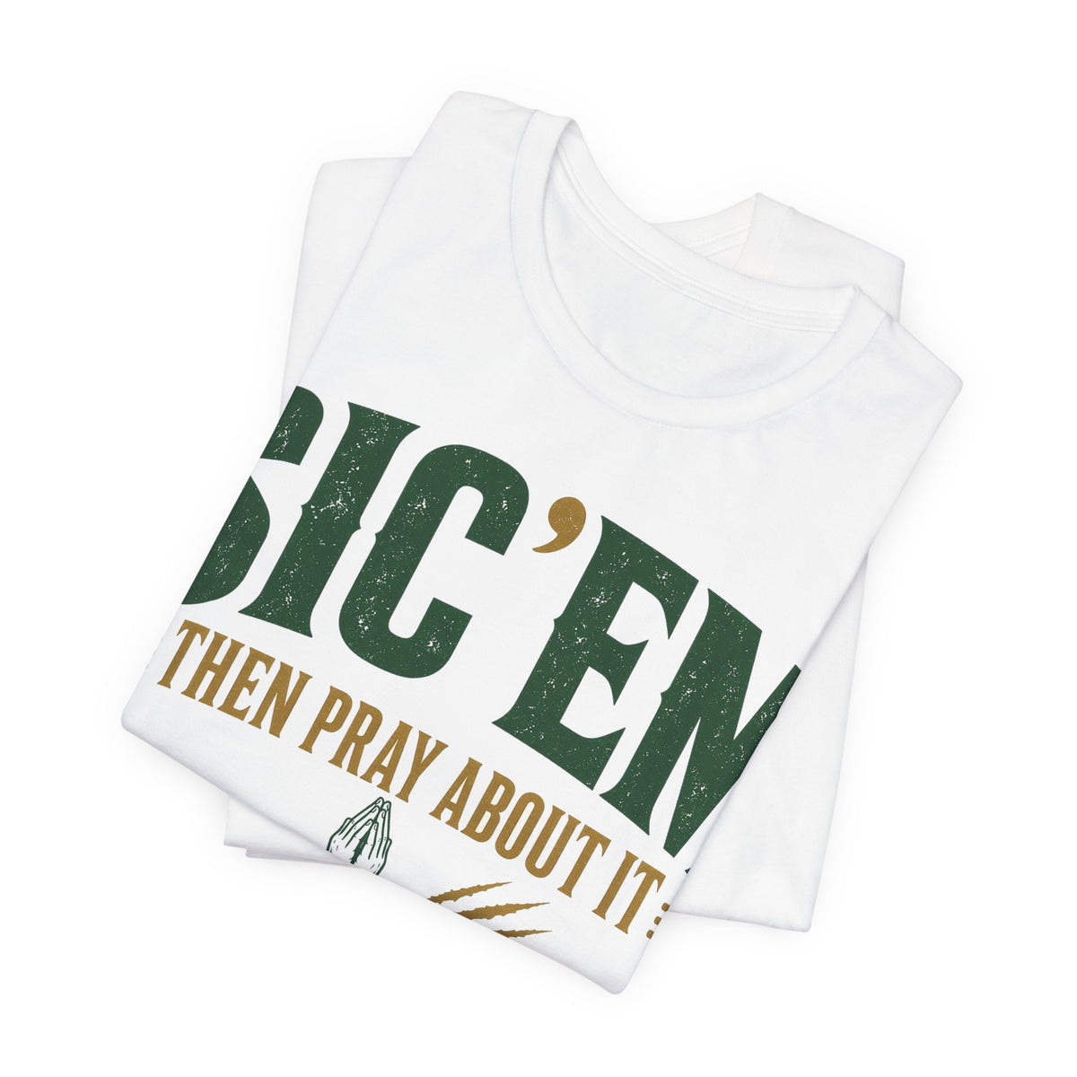 White folded tee stack with large diagonal 'SIC 'EM' text and prayer slogan