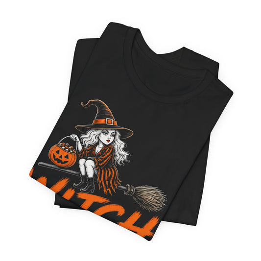 Black crewneck graphic tee with witch holding a jack-o’-lantern and orange text