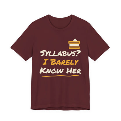 Maroon t-shirt with “Syllabus? I Barely Know Her” graphic and yellow book icon