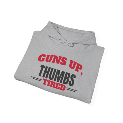 Folded sport grey pullover hoodie with drawstring hood and kangaroo pocket, “Guns Up, Thumbs Tired” print