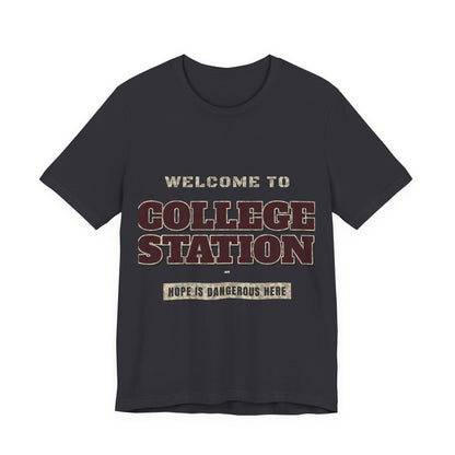 Dark grey crewneck T-shirt with “Welcome to College Station” graphic and slogan