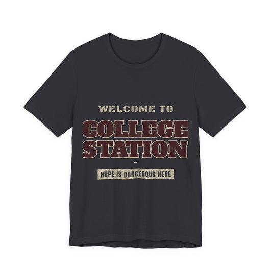 Dark grey crewneck T-shirt with “Welcome to College Station” graphic and slogan