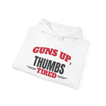 Folded white pullover hoodie with drawstring hood and kangaroo pocket, “Guns Up, Thumbs Tired” print