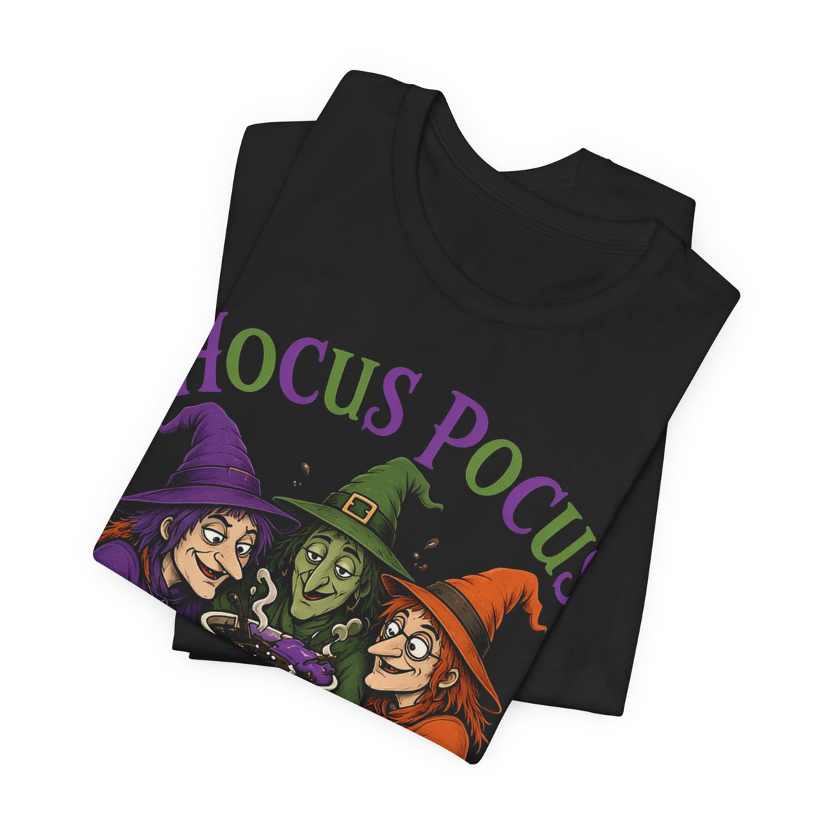 Black crewneck tee, folded, with partial witch-and-coffee graphic and 'Hocus Pocus' text