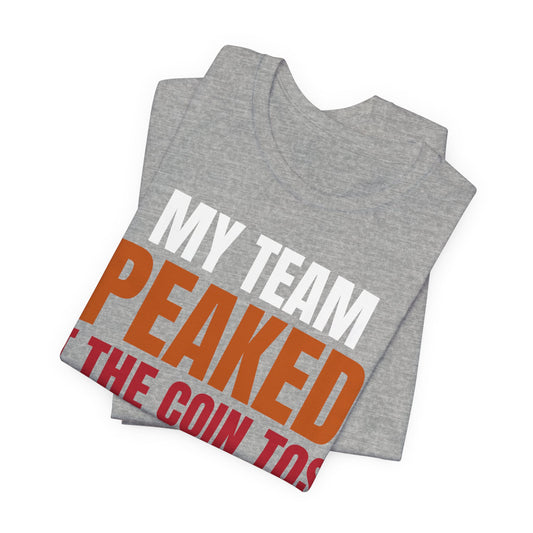 Heather gray folded tee with large 'MY TEAM PEAKED' and 'COIN TOSS' text print