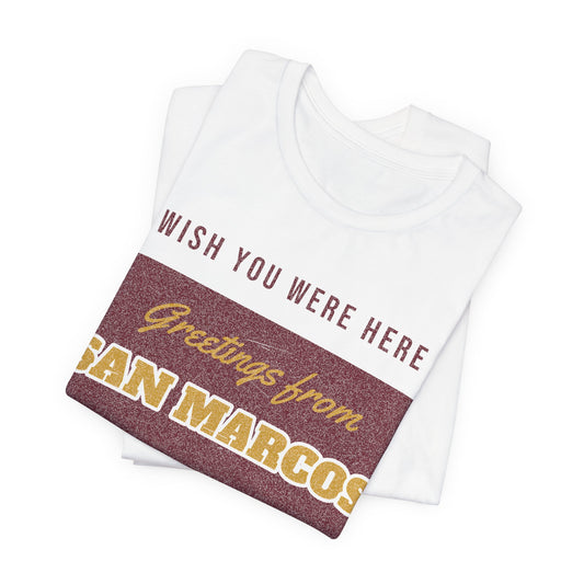 White crewneck graphic tee, folded, shows 'Greetings from San Marcos' design