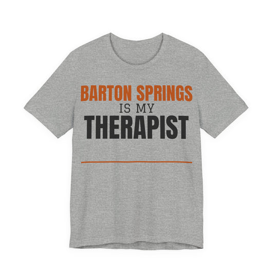 Heather gray T-shirt with orange and black 'Barton Springs is my Therapist' print