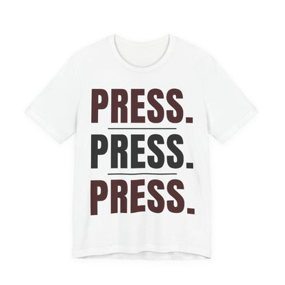 White graphic t-shirt with “PRESS.” text in stacked rows, short sleeves